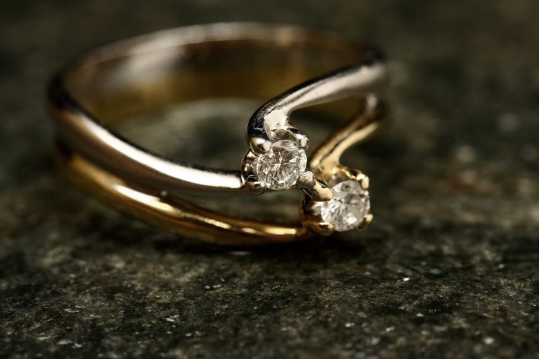 Minimalist gold band ring on a neutral surface