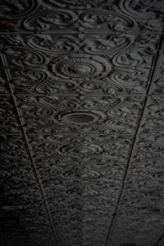 A grungy, textured ceiling with intricate, vintage patterns, perfect for backgrounds.
