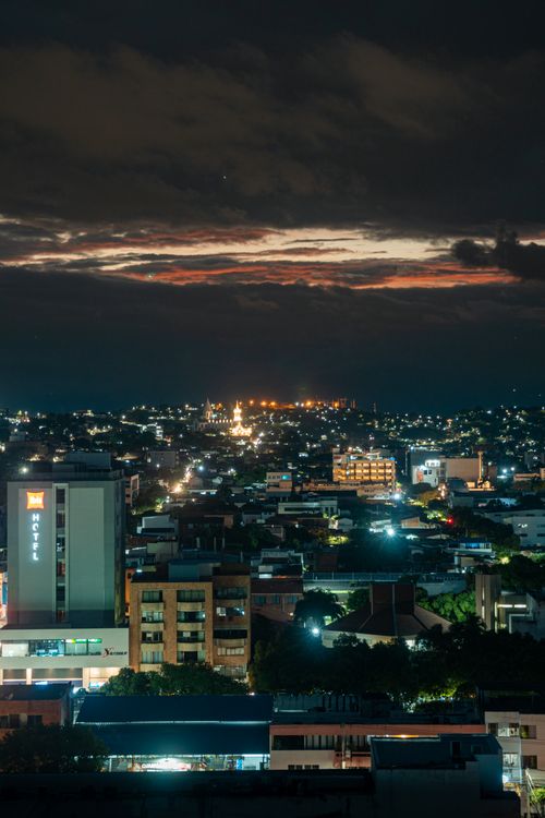 Free Vibrant city lights of Cúcuta, Colombia, under a dramatic evening sky. Stock Photo