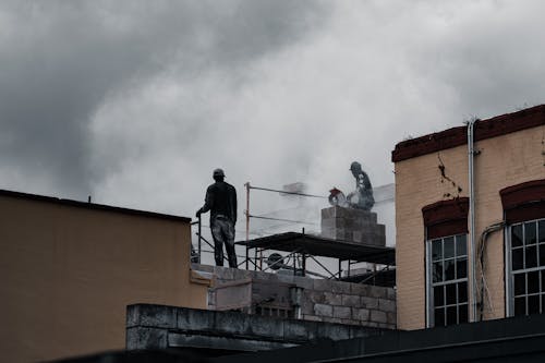 Men Working on Top of a Building