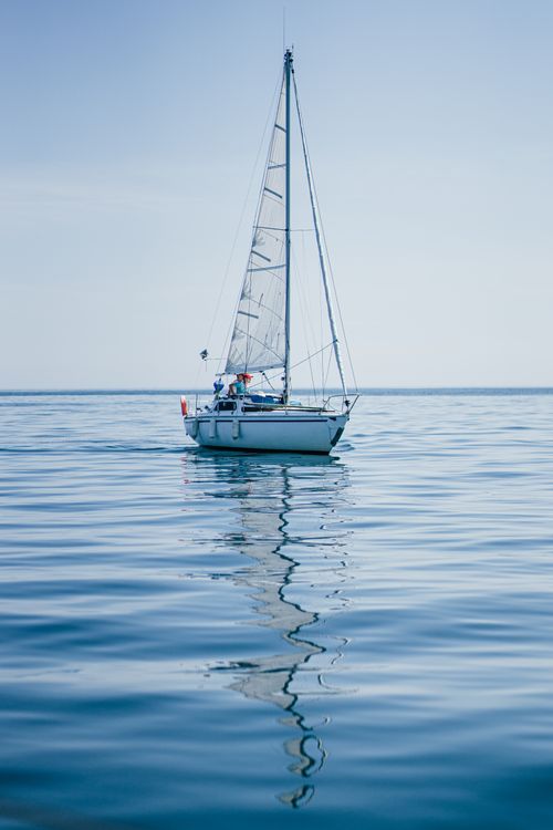 Free Peaceful sailboat reflecting in calm waters at Le Croisic, France. Ideal for travel and leisure themes. Stock Photo