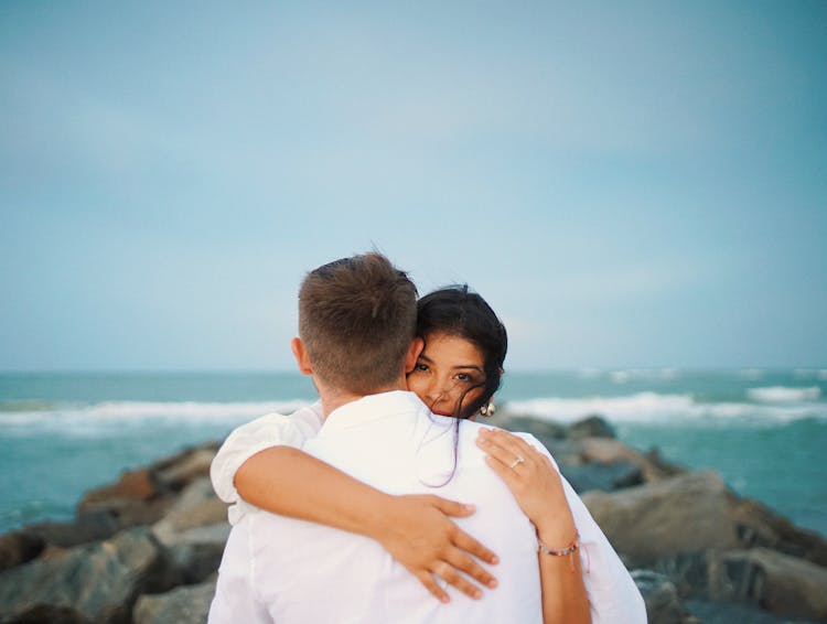 Couple Hugging On The Beach 