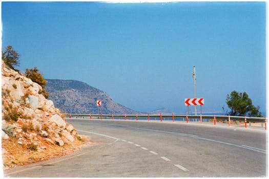 Beautiful curved mountain road in Vietnam under a clear blue sky.