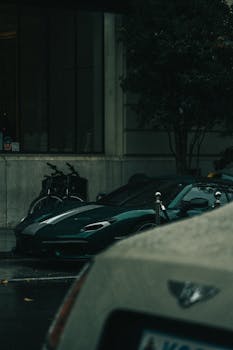A sleek sportscar parked on a rainy street in London, capturing the urban mood.