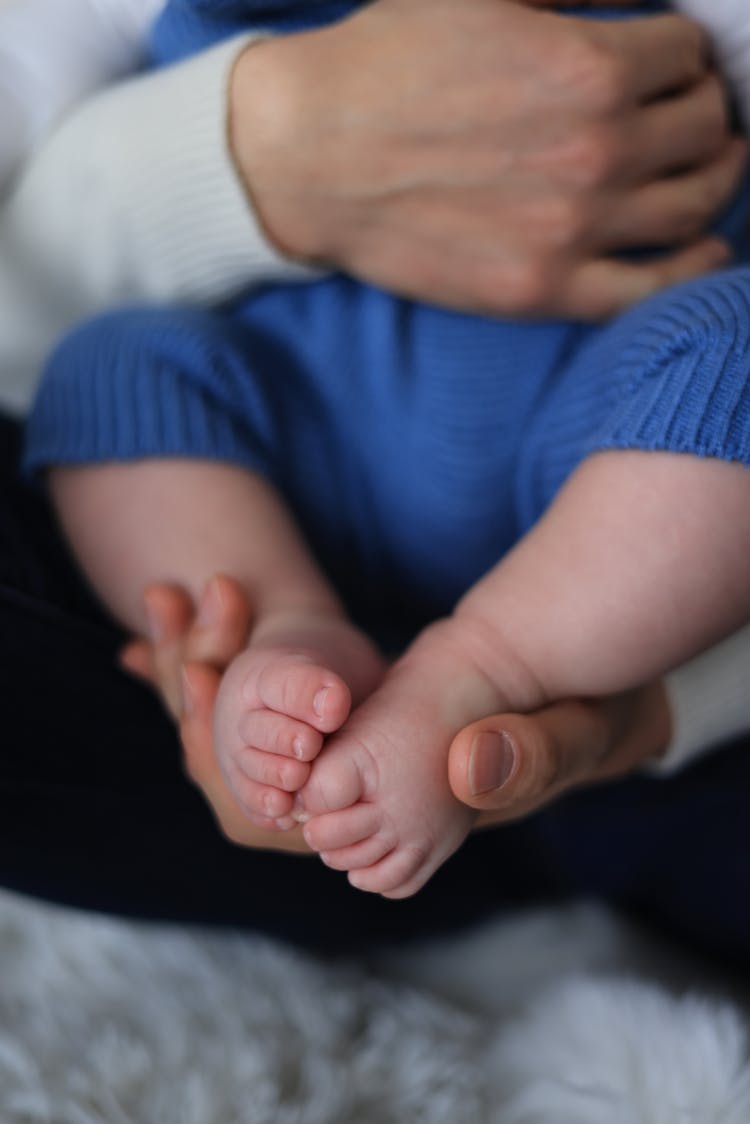 Hand Holding The Baby's Feet 