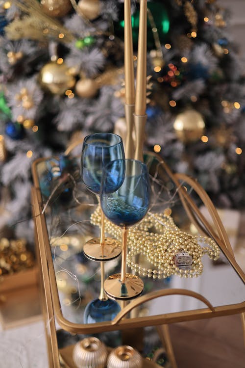 Blue Wineglasses on a Table on the Background of a Christmas Tree