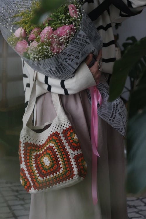 Woman with a Cotton Bag Holding a Bunch of Flowers 