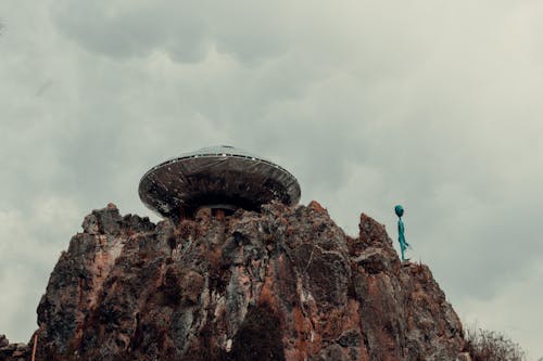 UFO and an Alien on a Rock Formation