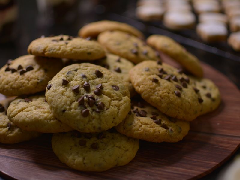 Freshly baked cookies cooling on a wooden tray