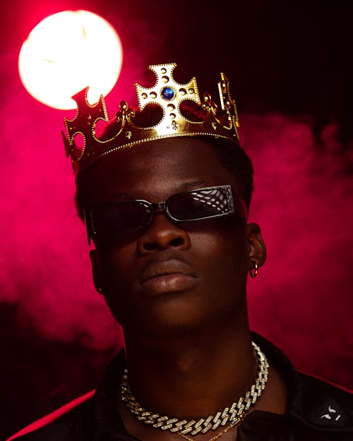 Man Wearing Sunglasses and Gold Crown
