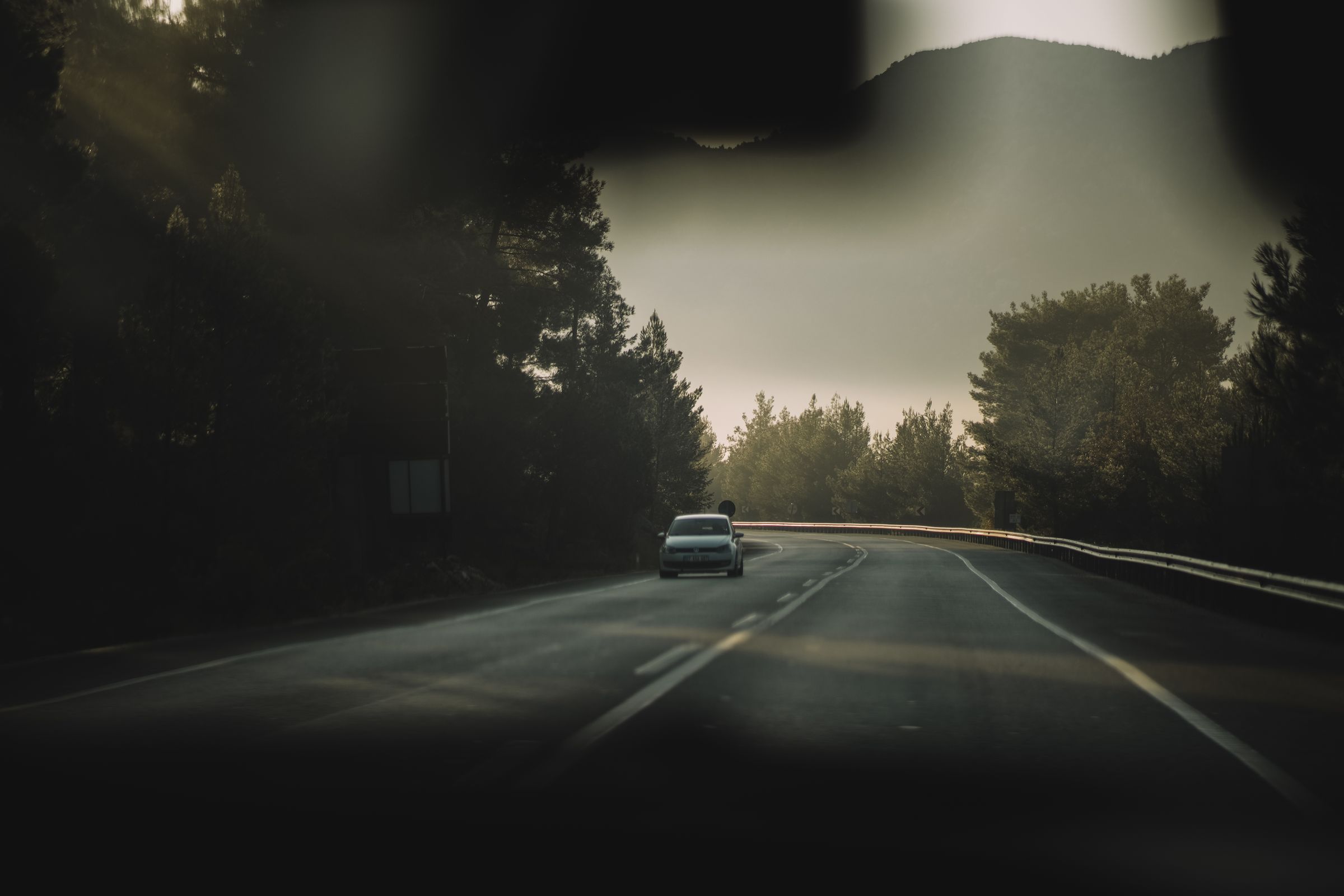 A car driving through a forest road