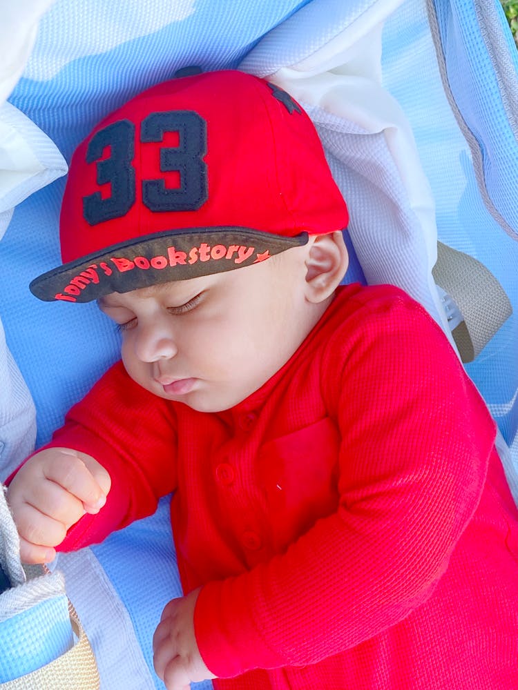 Baby Boy In Red Sweater Sleeping