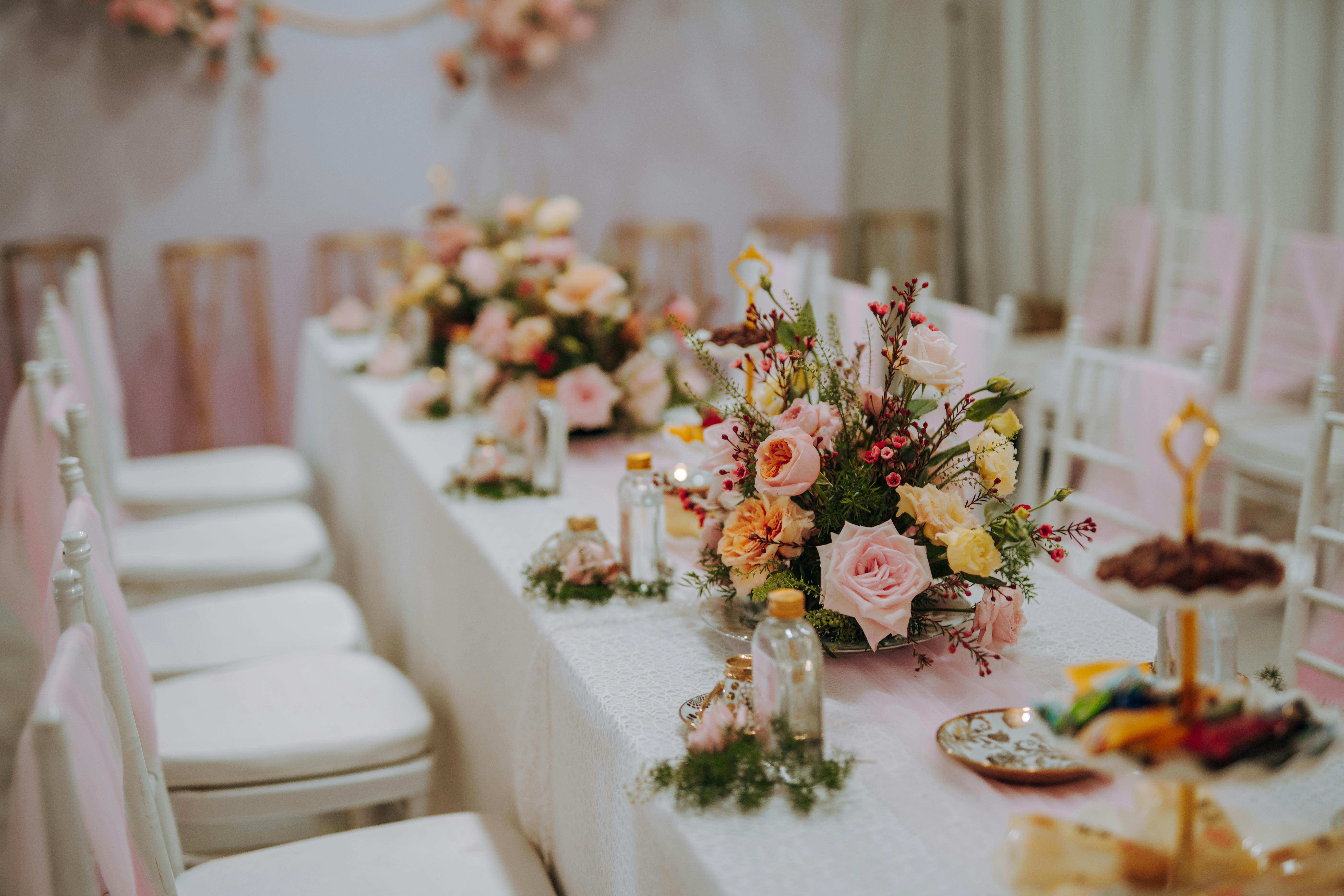 Beautifully decorated table with floral arrangements and pastel accents, perfect for events.