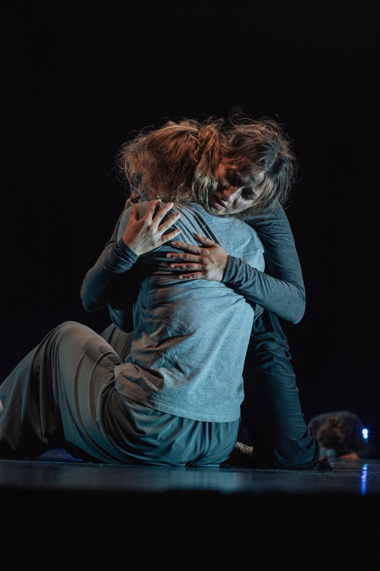 Young Women Acting And Performing A Dramatic Play On Stage