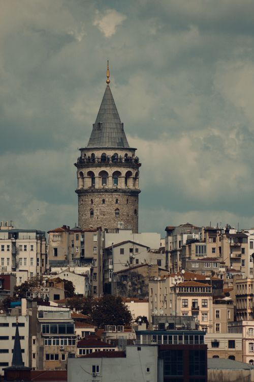 Free Stunning view of Galata Tower surrounded by Istanbul's unique architecture, capturing timeless allure. Stock Photo