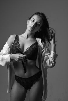 Artistic studio shot showcasing elegance in monochrome lingerie.