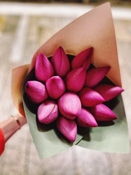 A stunning close-up of a bouquet featuring vibrant pink lotus flower buds.
