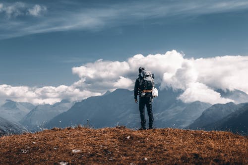 Man Standing on Rock During Sunset · Free Stock Photo