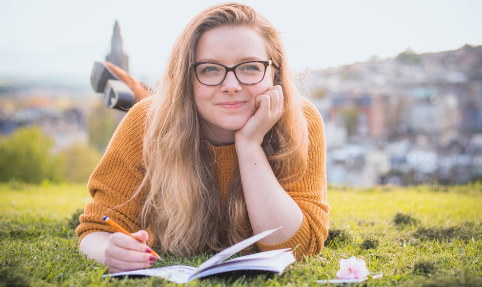 girl writing on her notebook