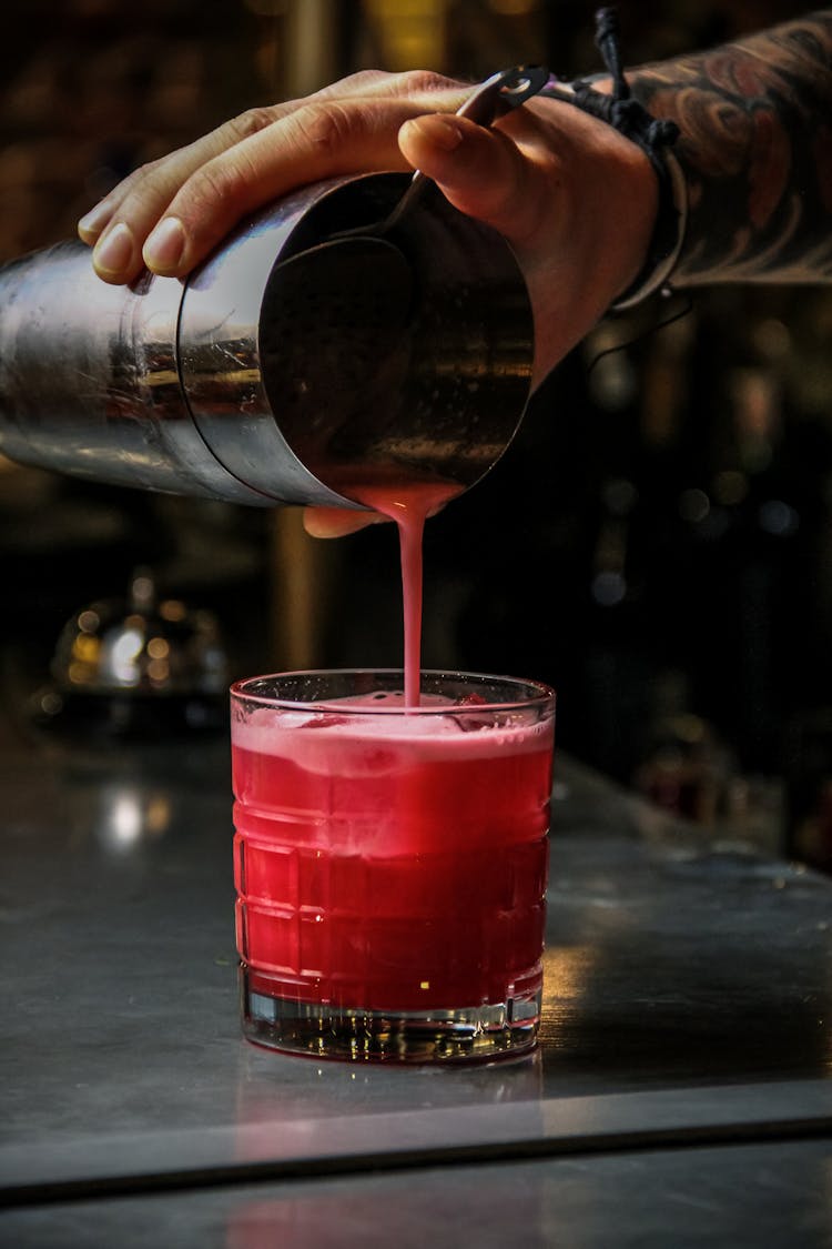 Man Pouring Drink Into Glass