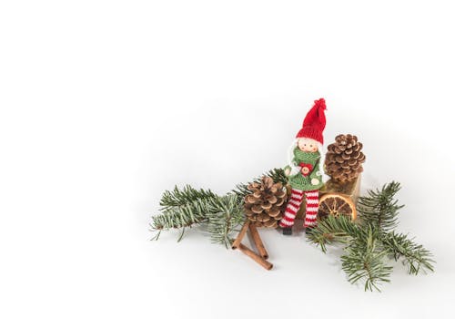 Free Doll Sitting Between Pine Cone Illustration Stock Photo