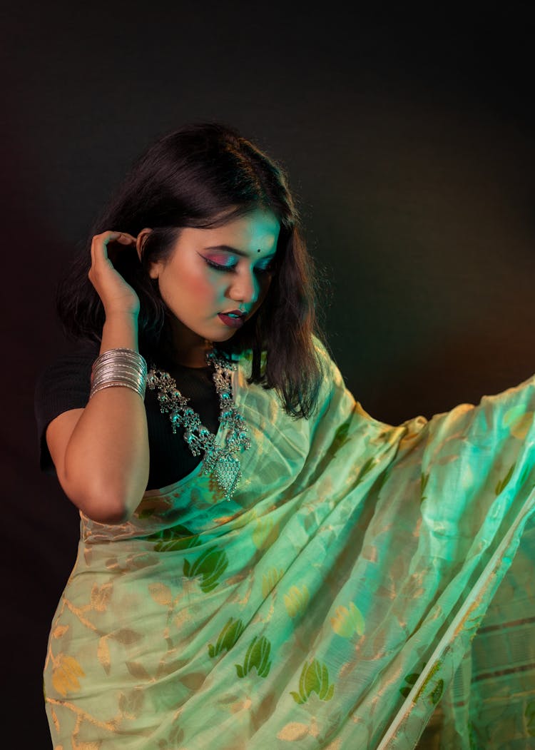 A Woman In Sari Wearing Silver Jewelries 