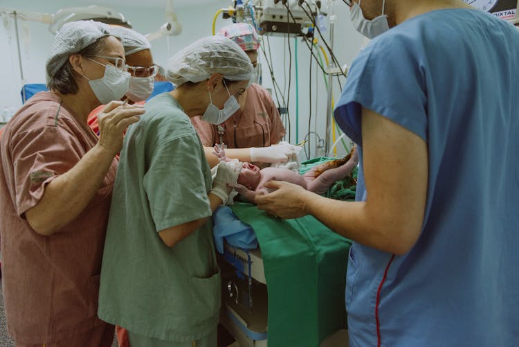 Doctors Delivering Baby In Hospital