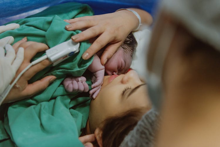 A Mother Holding Her New Born Baby 