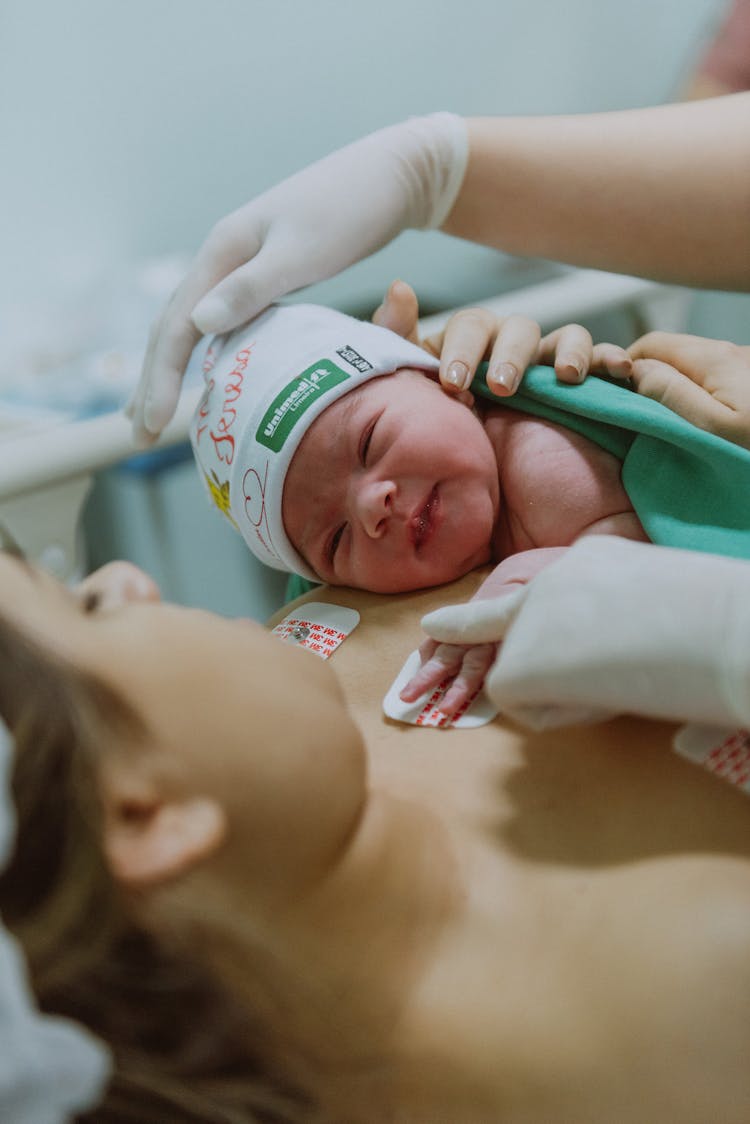 Cute Baby Lying On Mother Body After Labor