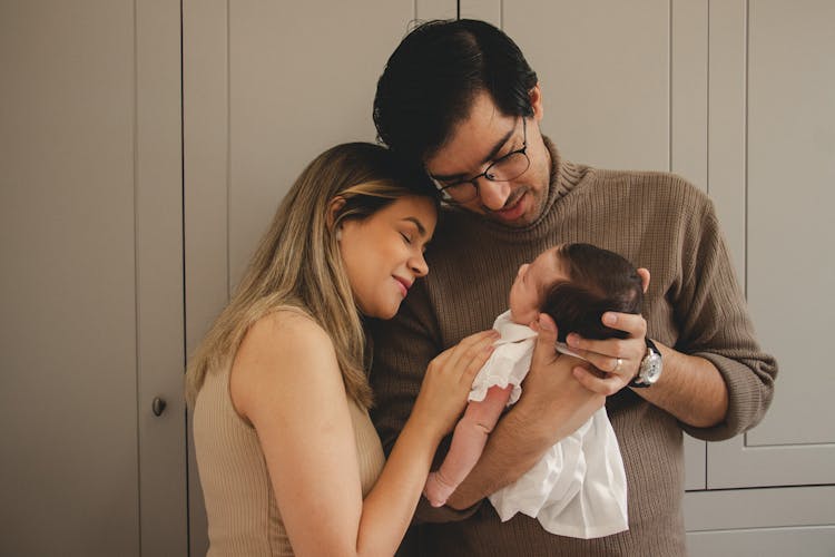 Young Parents Holding Newborn Baby