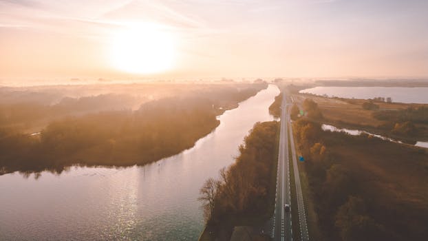 A breathtaking aerial view of a river and road at sunrise in Giethoorn, Netherlands.