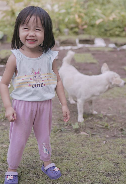A Cute Baby Girl in Pyjamas Laughing