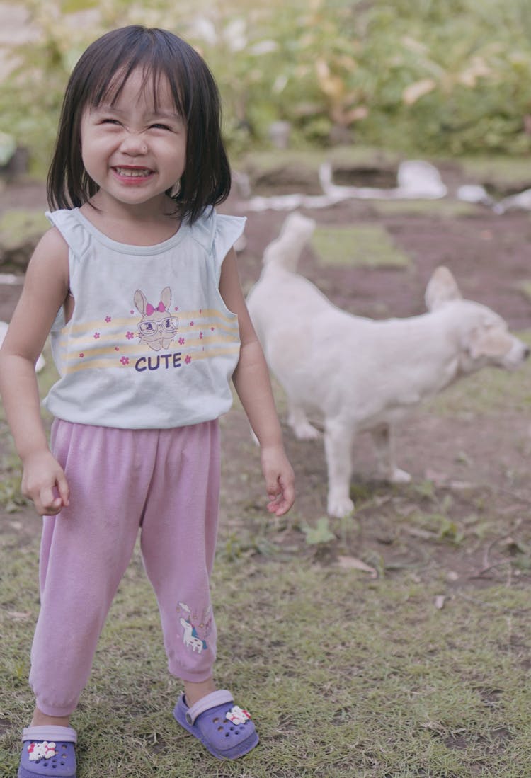 A Cute Baby Girl In Pyjamas Laughing