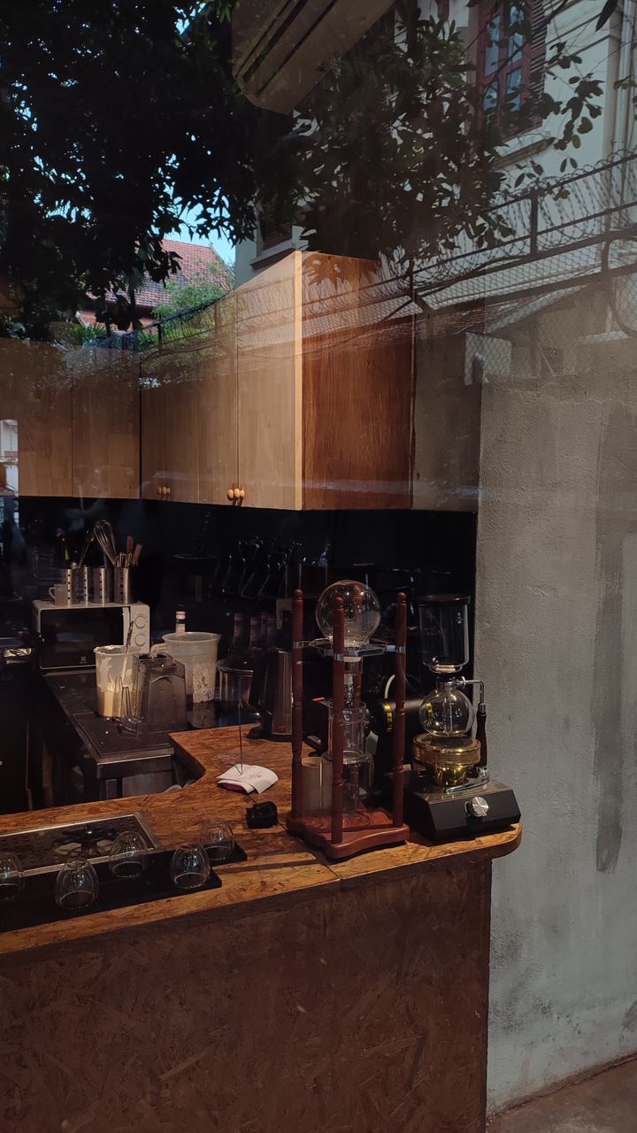 A farmhouse kitchen glass front coffee cabinet with interior LED lights displaying mugs and coffee beans