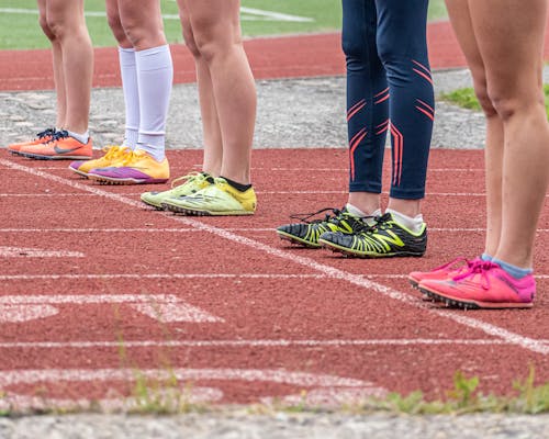 People Wearing Running Shoes Standing on the Track