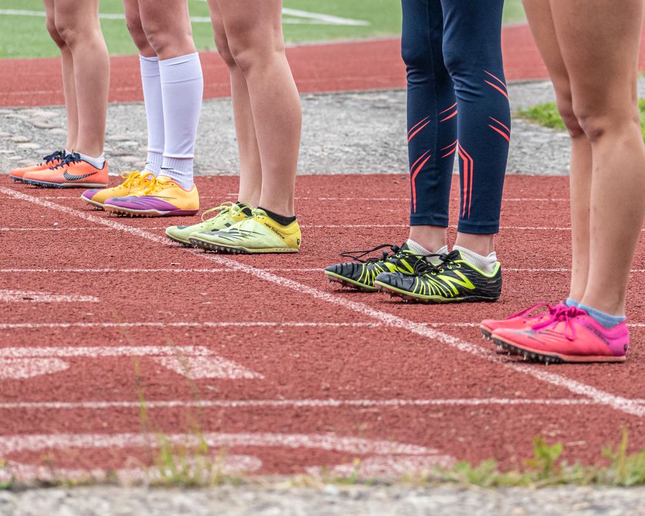 People Wearing Running Shoes Standing on the Track · Free Stock Photo