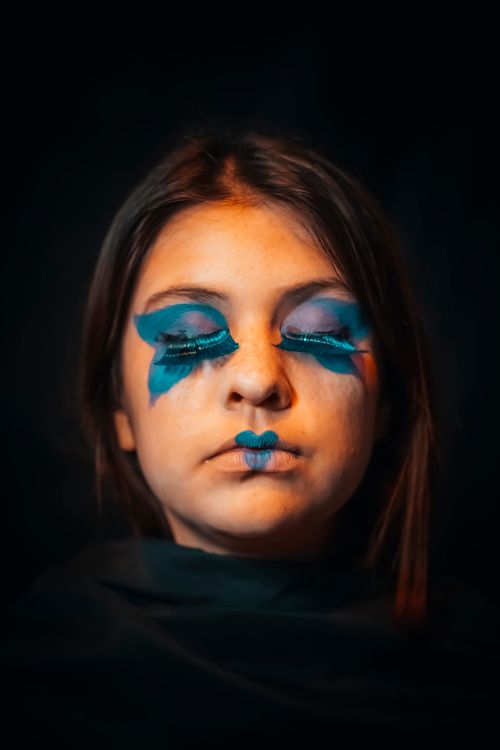 Free Close-up portrait of a woman with vibrant blue eye makeup in Buenos Aires. Stock Photo