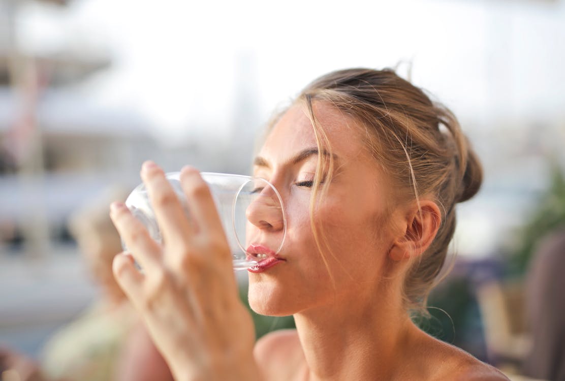 Free Woman Drinking from Glass Stock Photo