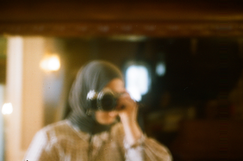 Free Artistic photo capturing a woman's blurred reflection with a camera in Bursa, Türkiye. Stock Photo