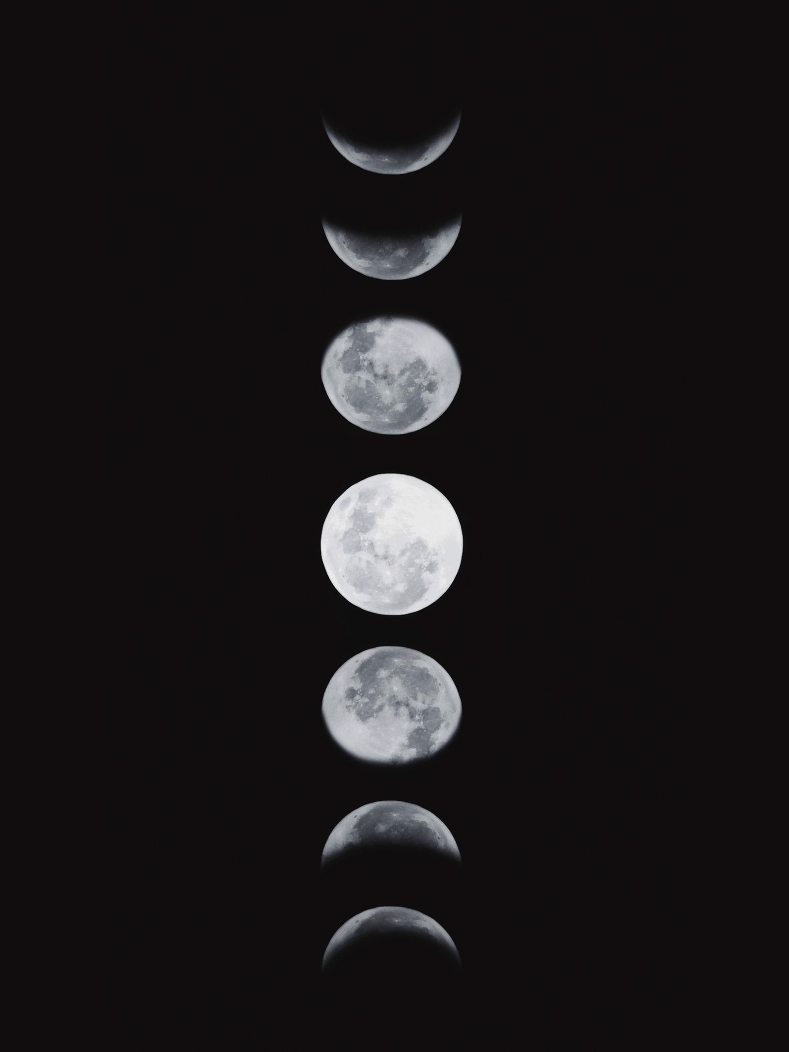 A vertical sequence showing the moon's phases against a dark sky