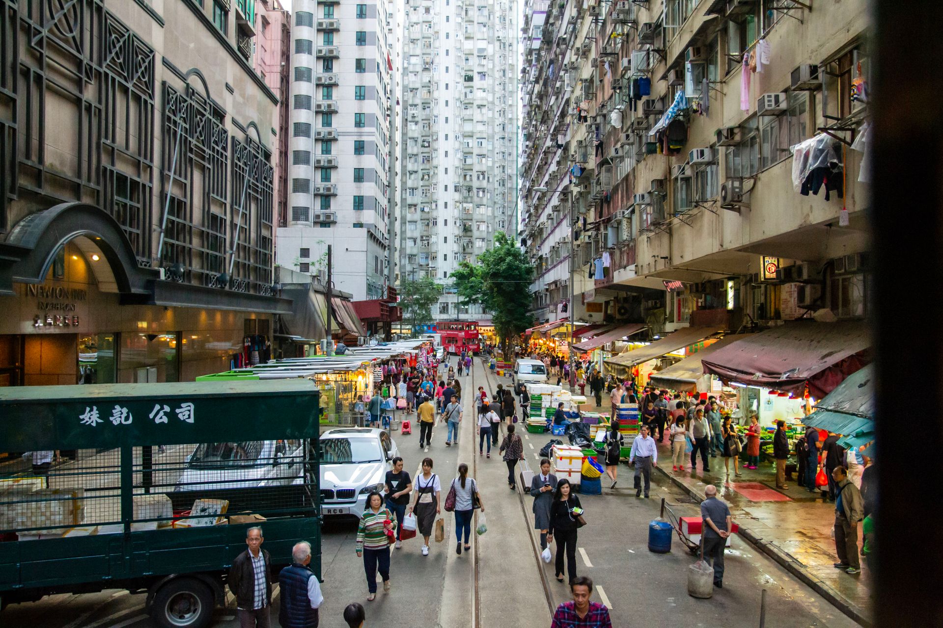 High-angle view of a busy urban market street in Hong Kong, capturing daily life and vibrant city energy.