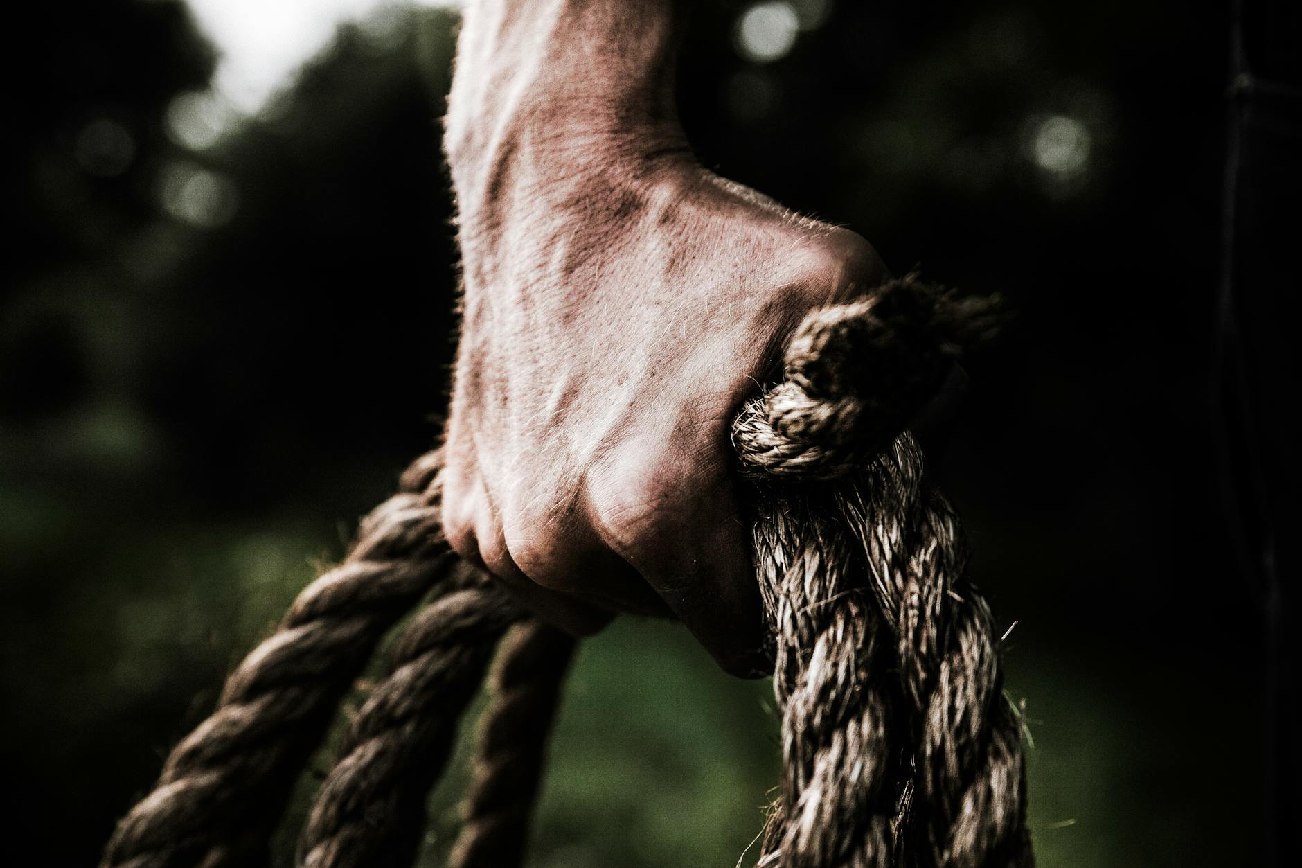 Man Holding Brown Rope