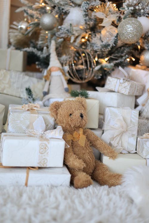 Free Christmas Gifts beside a Bear Plush Toy Stock Photo