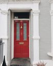 Red exit door in old building of modern city