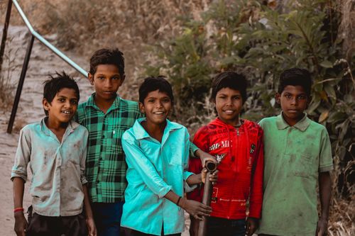 Free Five cheerful boys standing together in Udaipur, India, showcasing friendship and joy. Stock Photo