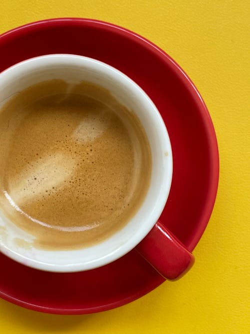 A Cup of Hot Coffee on Yellow Surface
