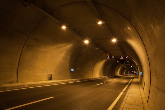 这是一张在光线昏暗的城市隧道里拍摄的长曝光照片，画面中有光线条纹和反射