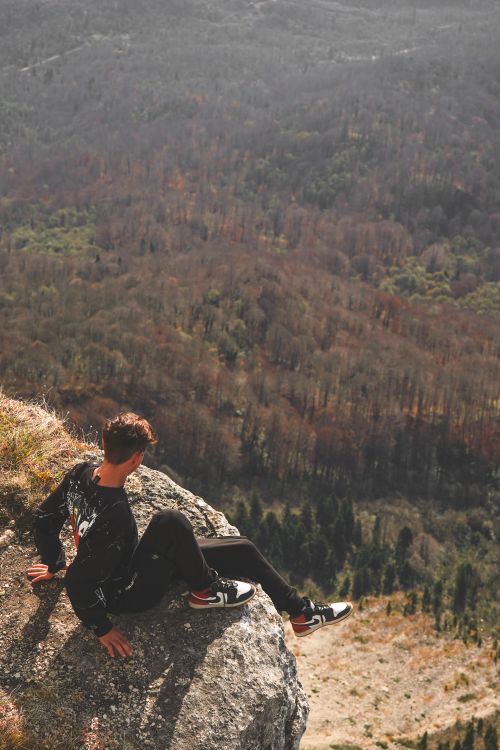 A Man Sitting on a Rock · Free Stock Photo