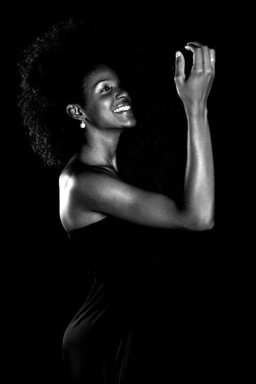 Grayscale Photo of Smiling Woman Wearing Dress