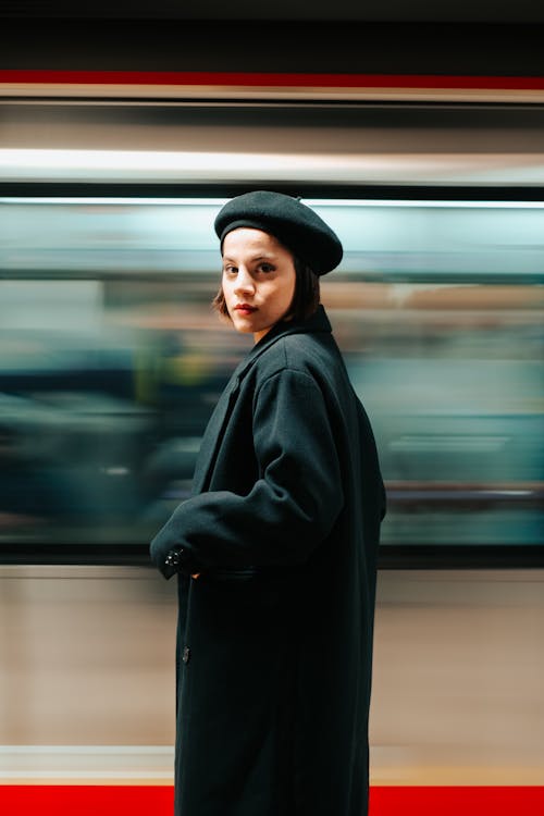 Woman Standing by a Moving Train